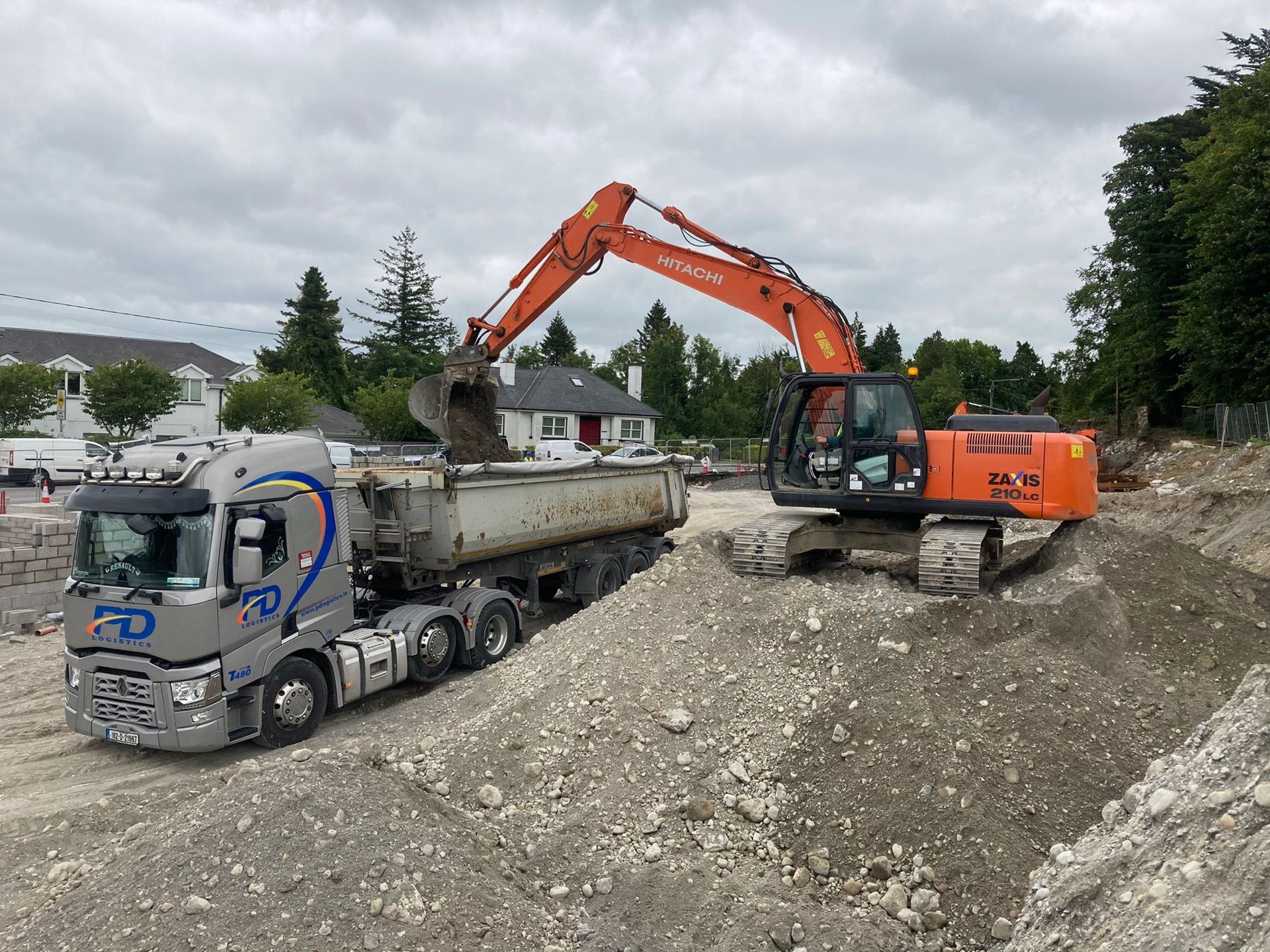 Excavator loading a PD Logistics tipper during site clearance